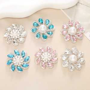 Detailed view of floral shoe charms with large pearls and sparkling rhinestones