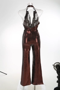 Macro view of burgundy sequined jumpsuit featuring a deep V backless halter neck design