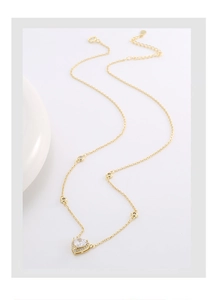 Detail of S925 silver heart necklace with zircon pendant and gold-plated finish
