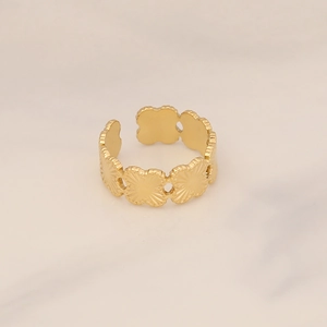 Detailed close-up of golden clover flower open ring with textured metal finish