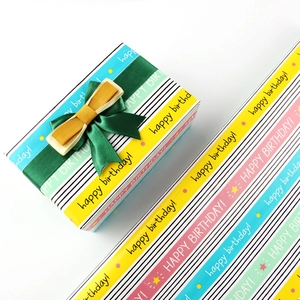 Detailed view of colorful striped happy birthday gift wrapping paper with ribbon bow