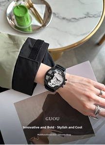 Close-up of a multifunctional quartz watch with black silicone strap and gear dial details