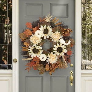 Close-up of white sunflowers and pumpkins on autumn wreath for Thanksgiving door decor