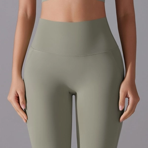 Close-up of olive green high-waisted yoga pants showing supportive wide waistband and fabric texture