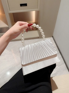 Elegant silver pleated satin evening bag featuring a decorative pearl beaded handle