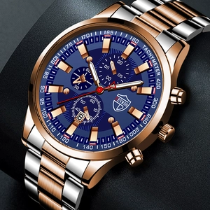 Detailed close-up of blue chronograph dial with luminous hands and steel gold bracelet