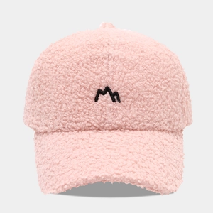 Close-up of pink sherpa fleece baseball cap featuring black mountain peak embroidery