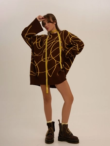 Oversized dark brown knit sweater with yellow abstract patterns and loose crewneck fit