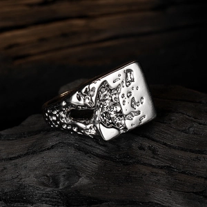Unique minimalist silver lava ring with abstract irregular texture on rustic dark wood