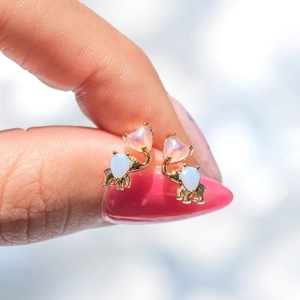 Golden elephant cartilage stud earrings featuring blue and pink opal stones in 85 characters