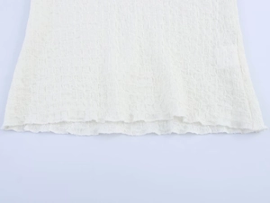Detail of white seersucker fabric texture and clean hem stitching on stylish women outfit