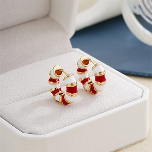 Detailed close-up of bamboo-style hoop earrings with red and white enamel inlays