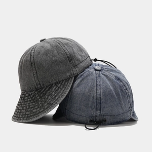 Detail of vintage denim docker hat with adjustable elastic drawstring and buckle closure