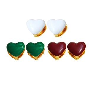 Three pairs of heart-shaped gold-plated clip-on earrings in white, green, and red enamel