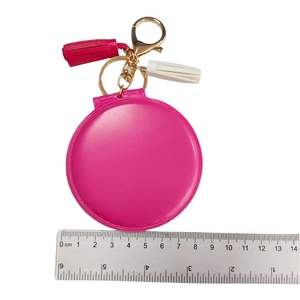 Detail of rose red faux fur pompom mirror keychain with leather tassel and gold lobster clasp