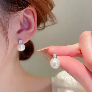 Elegant silver stud earrings featuring high-luster white pearls and zircon accents