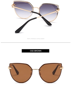 Detail view of cat eye sunglasses with purple gradient and brown lenses in gold frames