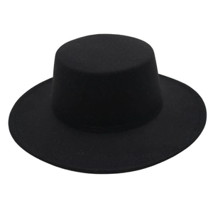 Close-up of high-quality black felt texture and wide flat brim of the wool fedora hat