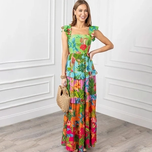 Detail of tiered maxi dress featuring vibrant tropical floral prints and pleated straps
