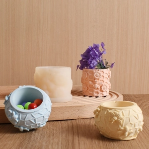 Detail view of honeycomb and bee embossed cylinders in four pastel matte colors