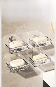 Detail view of wall-mounted 4-tier clear acrylic soap holder with drainage trays