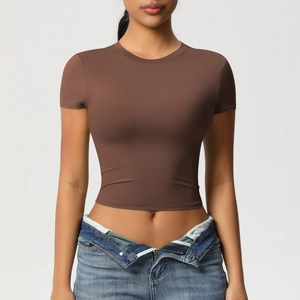 Close-up of brown slim fit cropped sports t-shirt in breathable high-stretch fabric