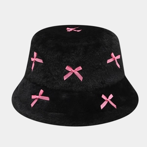 Close-up of black plush bucket hat featuring decorative pink silk bow accents
