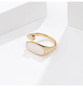 Detail of minimalist gold-plated silver ring featuring a white oval shell inlay