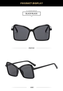 Front and side view of black oversized butterfly sunglasses with metal hinge accents