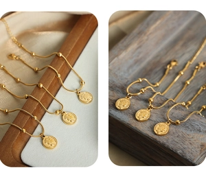 Detailed macro of gold plated stainless steel coin pendant featuring Elizabeth II motif