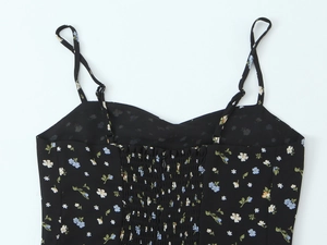 Detail of floral dress with adjustable straps and smocked back with hidden zipper