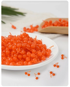 Realistic mini orange-red resin cherries in a white dish for DIY cake decoration