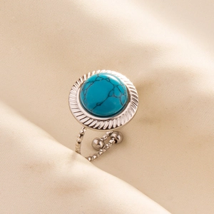 Detail of adjustable silver ring featuring a blue turquoise stone in a gear-shaped setting
