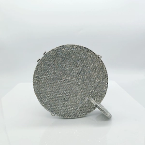 Detailed view of silver crystal cocktail clutch bag with sparkling rhinestone surface