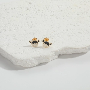 Vintage gold girl portrait stud earrings with black and white enamel finish