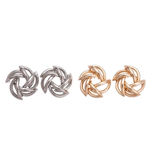 Metallic geometric hollow swirl knot earrings in polished gold and silver finishes