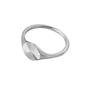 Detailed top view of a silver signet ring featuring an engraved sunburst pattern