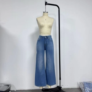 Detail of high waist wide leg jeans with vintage washed blue finish and five-pocket design