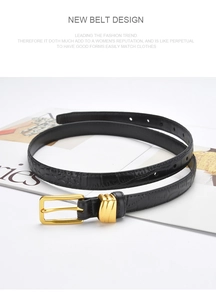 Detail showing the crocodile pattern texture and golden buckle on this black leather belt