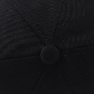Detailed view of cotton baseball cap crown with matching fabric button and stitching