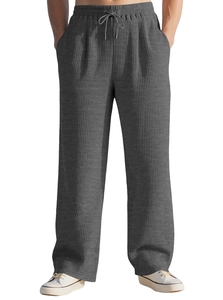 Detailed macro shot of grey striped corduroy fabric texture and drawstring waistband