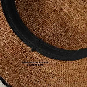Detail of the inner straw hat sweatband featuring a small loop for windproof rope attachment