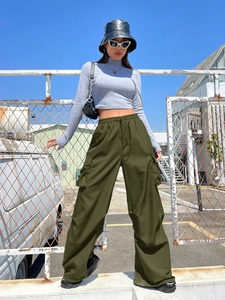 Close-up of olive green cargo pants with elastic waistband and large side pockets