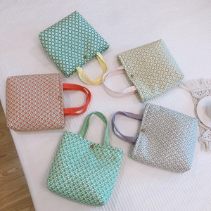 Five assorted floral cotton lunch bags with metal buckles in multiple fresh colors