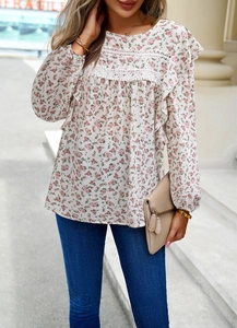 Detail of floral print blouse with lace trim and ruffled shoulders for a casual look