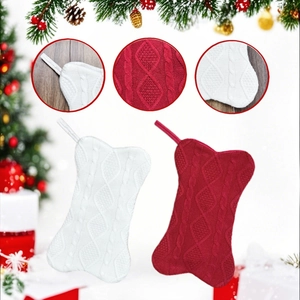 Knitted bone-shaped Christmas stockings in red and white with diamond cable patterns
