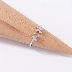 Close-up of silver open ring featuring double cross details with sparkling cubic zirconia