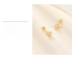 Macro shot of 18k gold plated stud earrings featuring three zircon stones in a triangle set