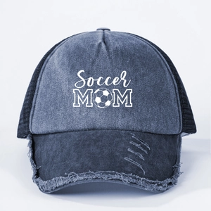 Detail of Soccer MOM print on vintage navy denim trucker hat with distressed brim edges