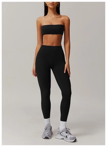 Macro shot of high-elasticity black sports bra and high-waisted fitness leggings set